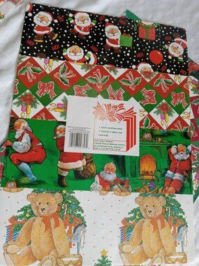A good number of old but new vintage Christmas gift wrap, some in their plastic